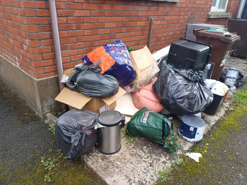 Bagged household rubbish, cardboard and storage containers before the Ballymena clearance